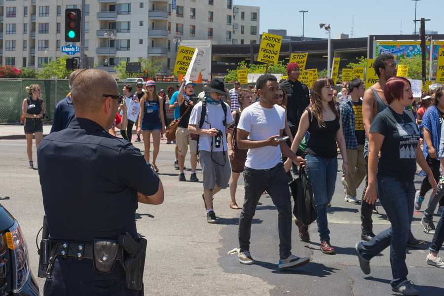 Los Angeles CA USA - May 02 2015: Police watching Protesters during march against the death of Freddie Gray a man of Baltimore who was seriously injured in police custody.