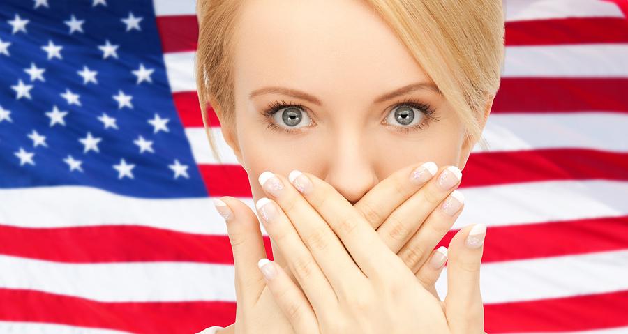 usa politics, conspiracy and secrecy concept - woman with hands over mouth on american flag background