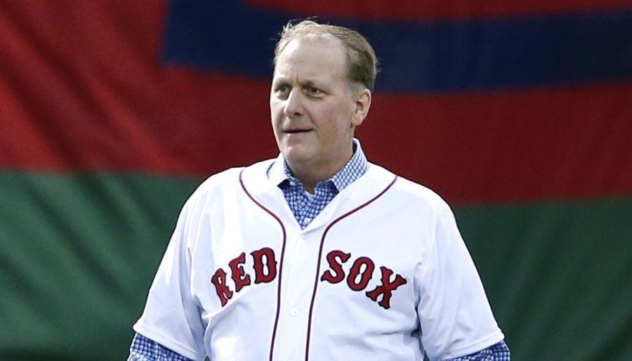 Former Boston Red Sox pitcher Curt Schilling walks with his son, Garrett, onto the infield at Fenway Park prior to a baseball game against the Atlanta Braves in Boston, Wednesday, May 28, 2014. The Red Sox honored the 2004 World Series team prior to the game. (AP Photo/Elise Amendola)