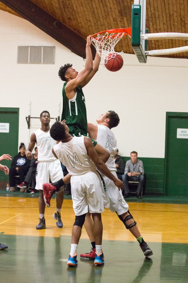 Photo by David Barron: Isaiah Fontaine ’16 scores against defenders.