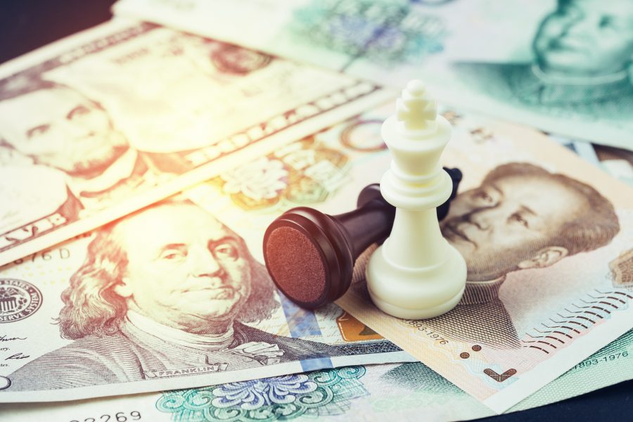 US and China finance tariff trade war concept, black loser and white winner chess king on US dollar and china yuan banknotes, world major market countries, import and export barrier. Purchased from BigStock.com. 