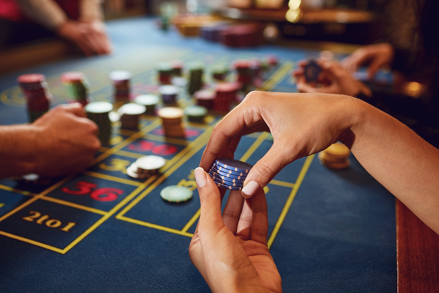 Gamer play casino roulette at a table in a casino. Betting gambling poker roulette background concept. Photo purchased from BigStock.com.