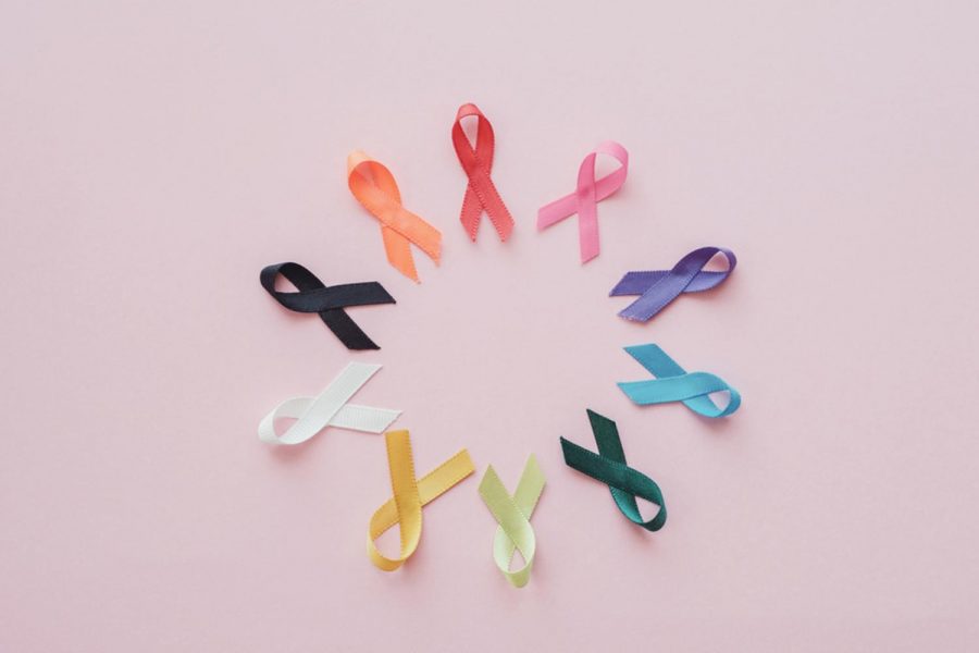 Colorful ribbons on pink background, cancer awareness. Photo illustration purchased from BigStock.com.
