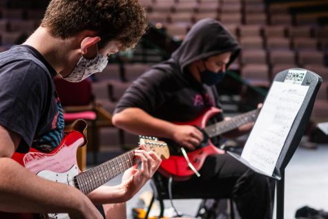 Kieran Cross 23 (front) and Jack Nathanson 23 play the guitar during a rehearsal. You can tell that everyone put in the effort this year to be able to play during COVID times, and I am grateful for having it at all this year, Cross said.