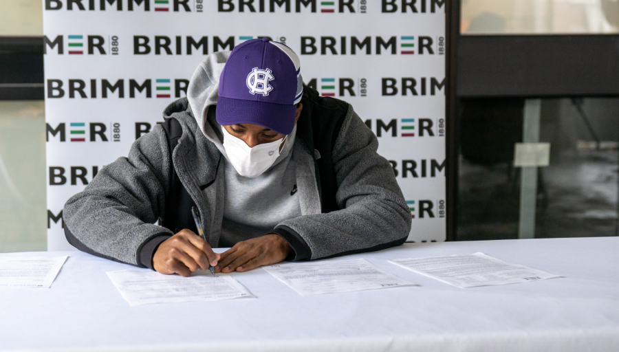 Kyrell Luc 21 signs on to play D-1 basketball with Holy Cross. Photo by Nicole DeCesare.
