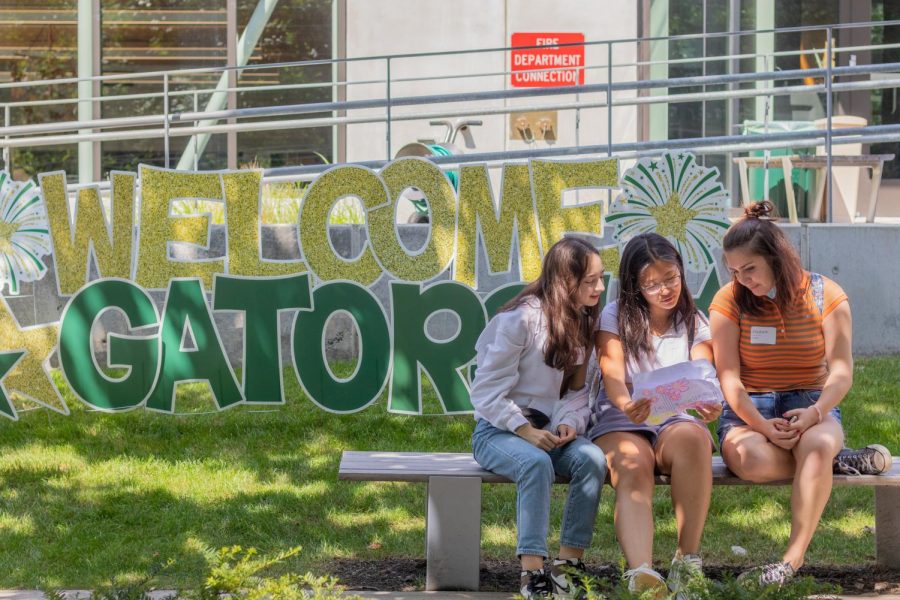 Madeline Hsiao 23, Hebe Qiang 23, and Libby Barker-Hook 23 sit outside on the first day of school.