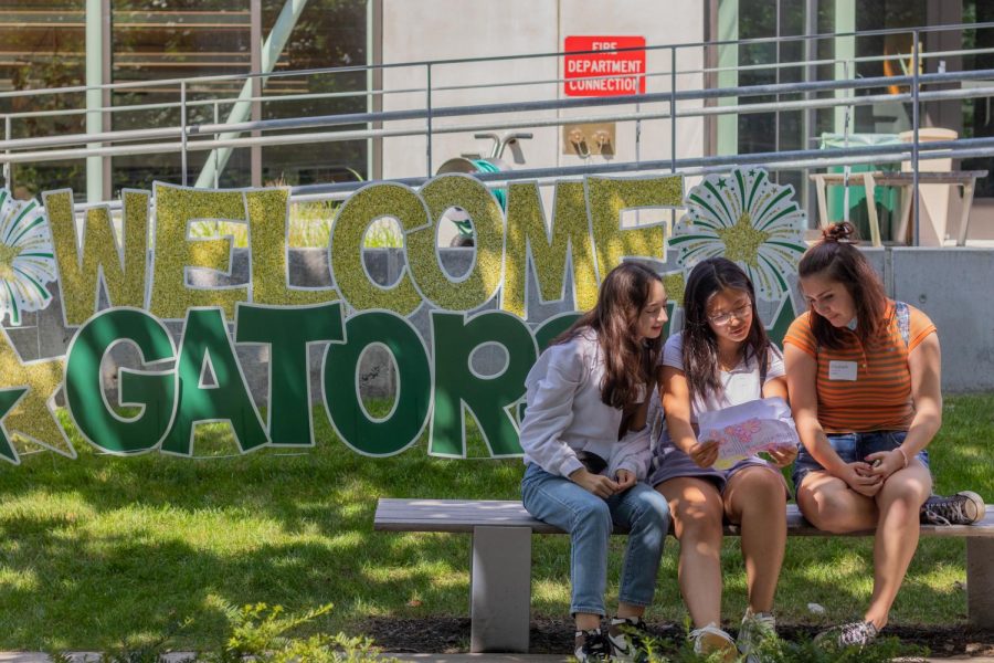 Madeline Hsiao 23, Hebe Qiang 23, and Libby Barker-Hook 23 sit outside on the first day of school.