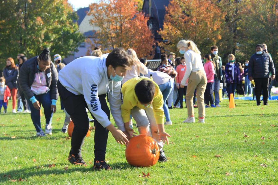 Will Apen 25 helps his Lower School buddy during the pumkin roll. 