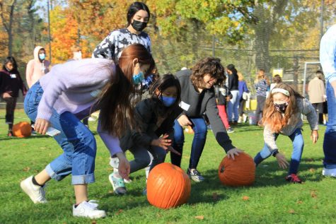 Students from all divisions compete in the pumpkin roll. 