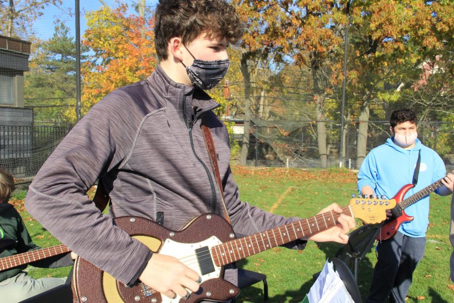 Kieran Cross 23 provides some rythm on the guitar. 