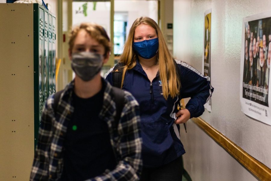 Zak Adler 23 and Alison Rimas 23 walk down a one-way hallway last year, one of many health restrictions we have moved past since the start of the pandemic.