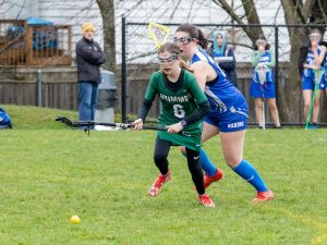 Lucie Shimomura 28, a 7th-grade athlete, plays a varsity lacrosse game against The Waring School.