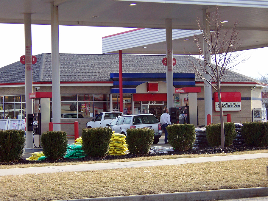 Man pumping gas at city gas station. Photo purchased by BigStock.