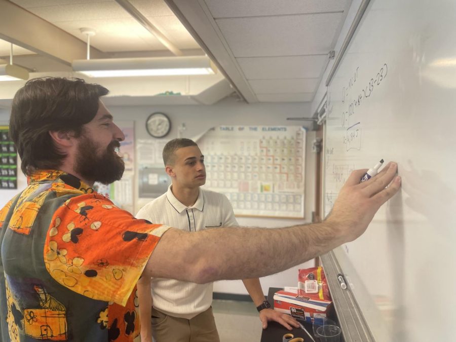 Jared Smith teaches Owen Williams 23 during chemistry. 