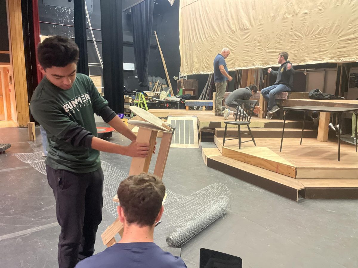 Director Bill Jacobs stagecraft crew helps to put together the set for the fall play. 
