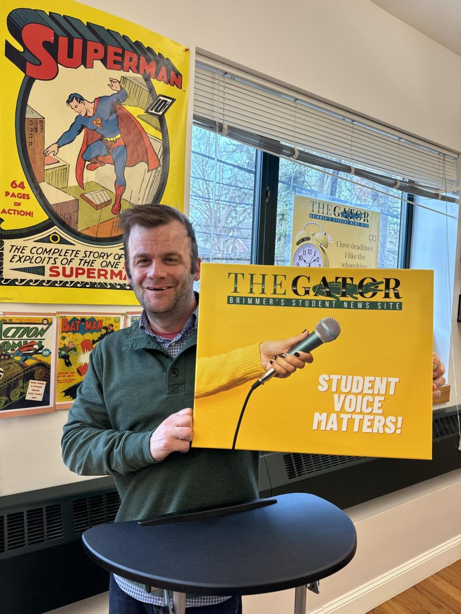 History and journalism teacher David Cutler 02 poses with his favorite posters. 