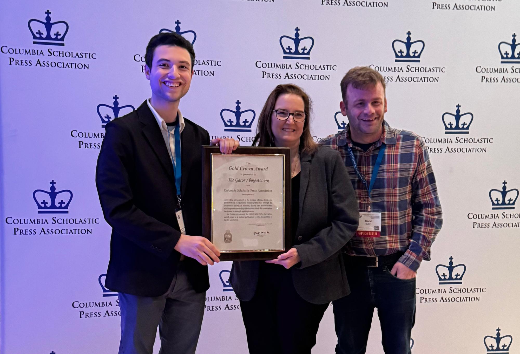 Co-Editor-in-Chief Evan Michaeli 23 poses with CSPA Director  Jennifer Bensko Ha and Adviser David Cutler upon receiving the Gold Crown.