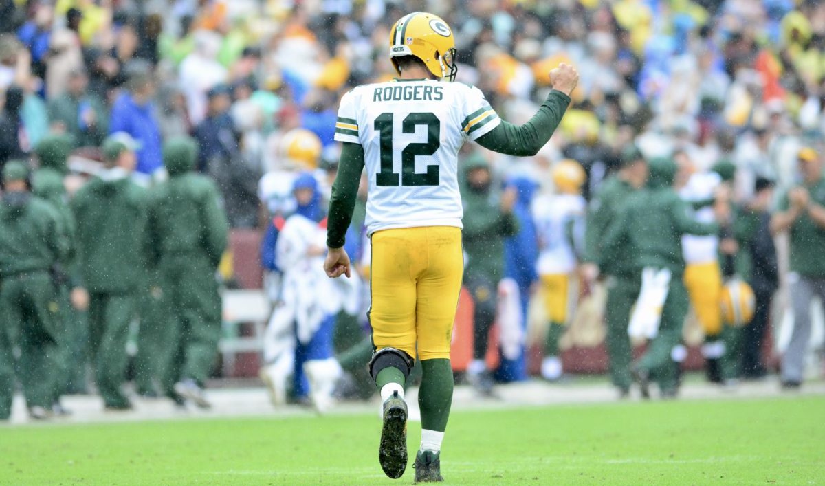 Aaron Rodgers commands the offense as a Green Bay Packer. Rodgers's debut as a New York Jet was cut short after an Achilles injury. 