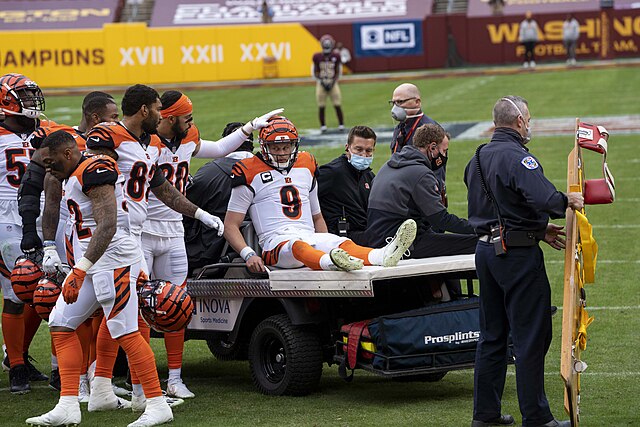 Cincinnati Bengals quarterback Joe Burrow sits in a cart after an injury against the Washington Commanders in 2020. Burrows injury is one of many that quarterbacks have suffered, which should be a wake-up call to the NFL. 