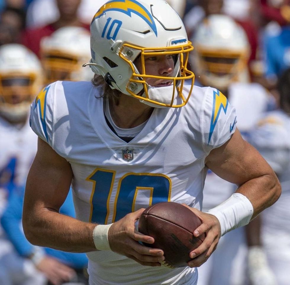 Los Angeles Chargers quarterback Justin Herbert runs with the ball against the Washington Commanders. Herbert has one of the strongest arms in the league, often throwing for several hundred yards a game. Herbert broke his finger in Week Fourteen. 