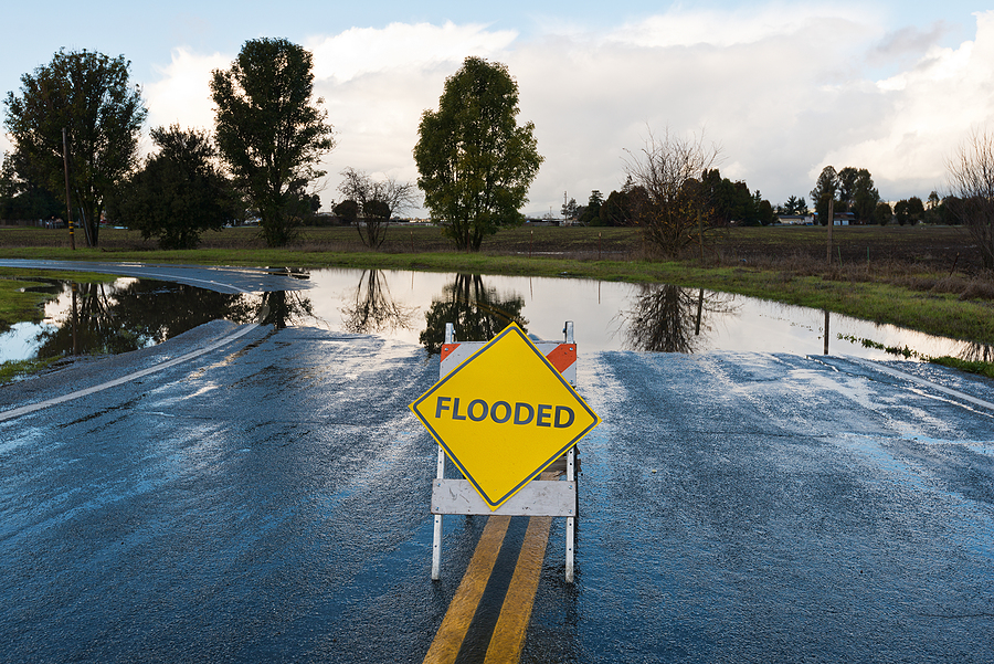 Flooded warning sign on an impassable road San Martin, California.