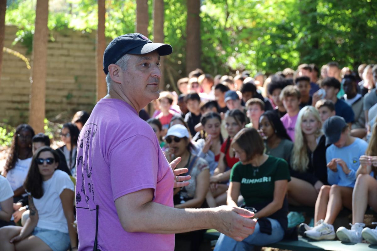 Upper School Head Joshua Neudel welcomes students to camp in the amphitheater. 