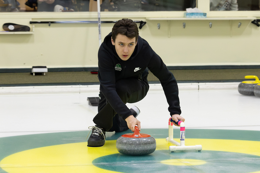 Noah Panto '25 throwing a stone. 