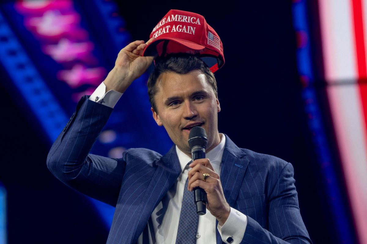 Charlie Kirk, Turning Point USA founder, puts on a MAGA hat during the AmericaFest 2024 conference sponsored by conservative group Turning Point in Phoenix, Arizona, U.S. December 19, 2024.  REUTERS/Cheney Orr