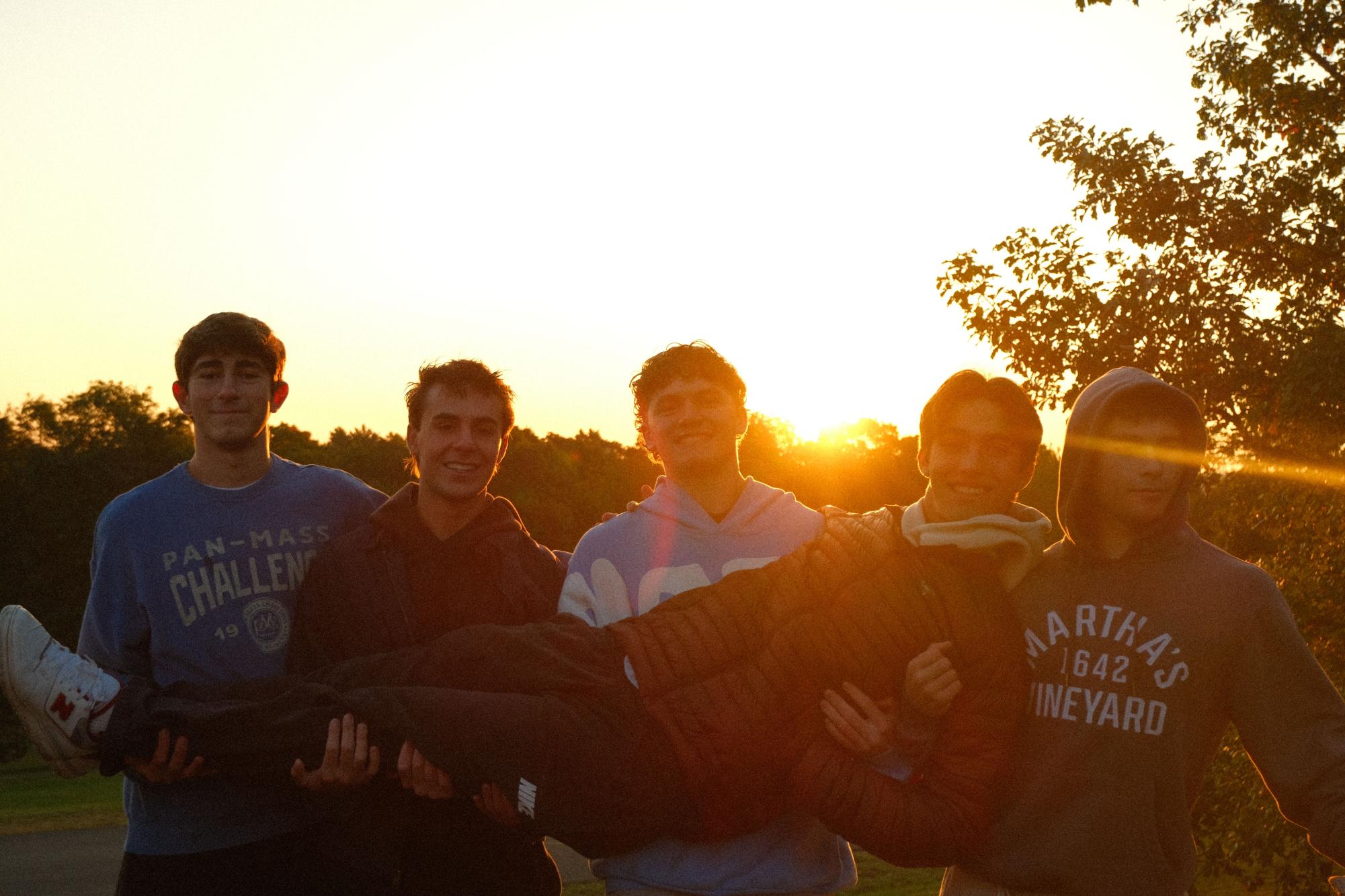 Seniors gathered in small groups on the grass, waiting for the sunrise before heading to school.