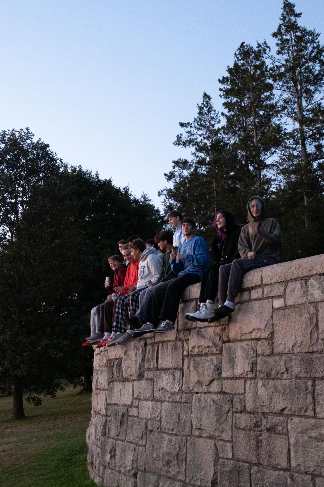 Seniors gathered in small groups on the grass, waiting for the sunrise before heading to school.