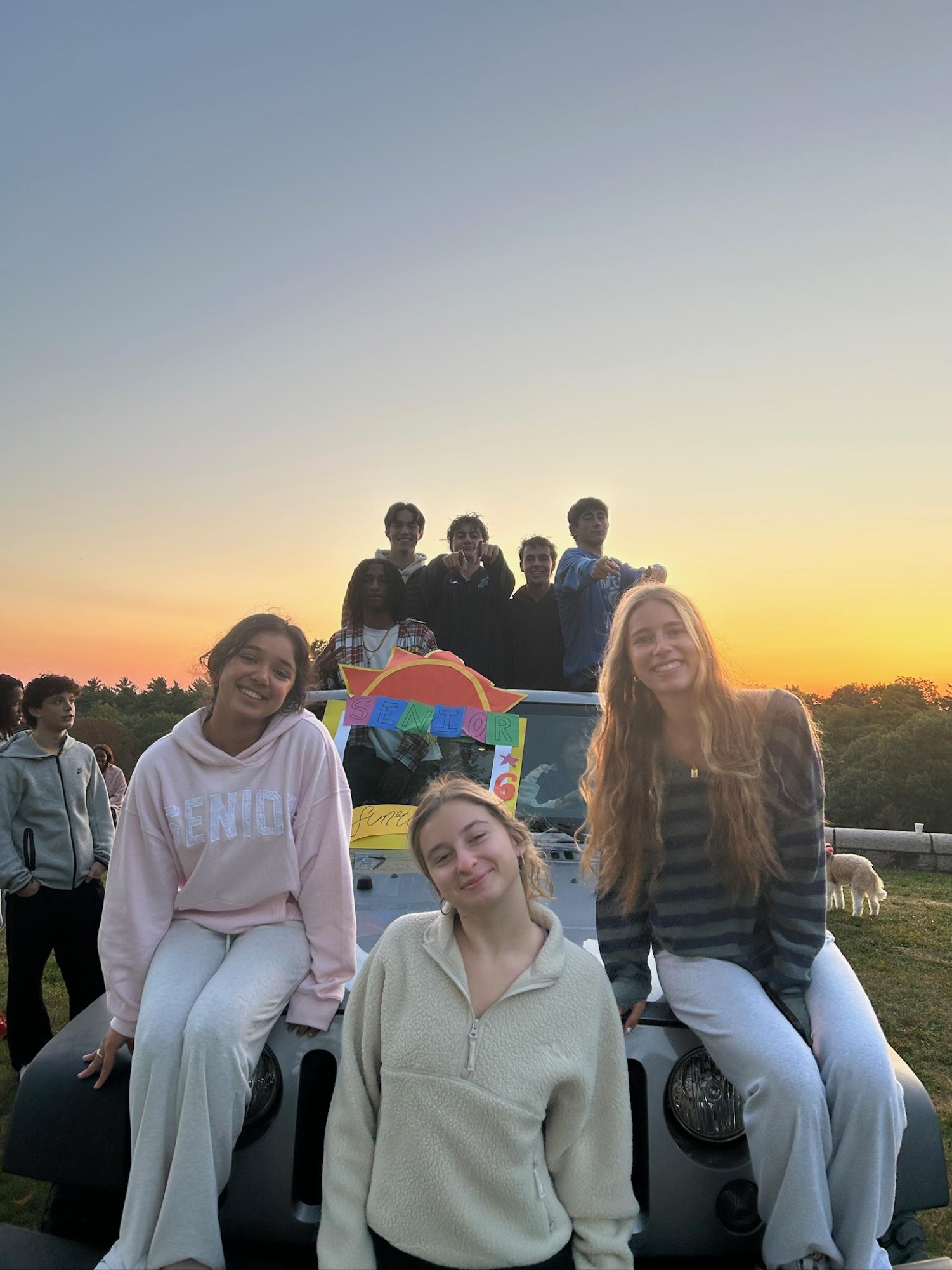 Seniors gathered in small groups on the grass, waiting for the sunrise before heading to school.