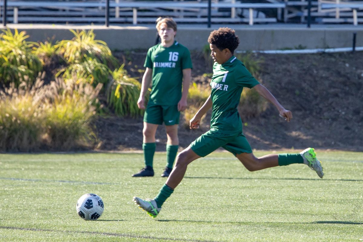 Charlie Young '29 and Rimon Zhao '27 high-five after Rimon scores a goal against Boston Trinity Academy. 