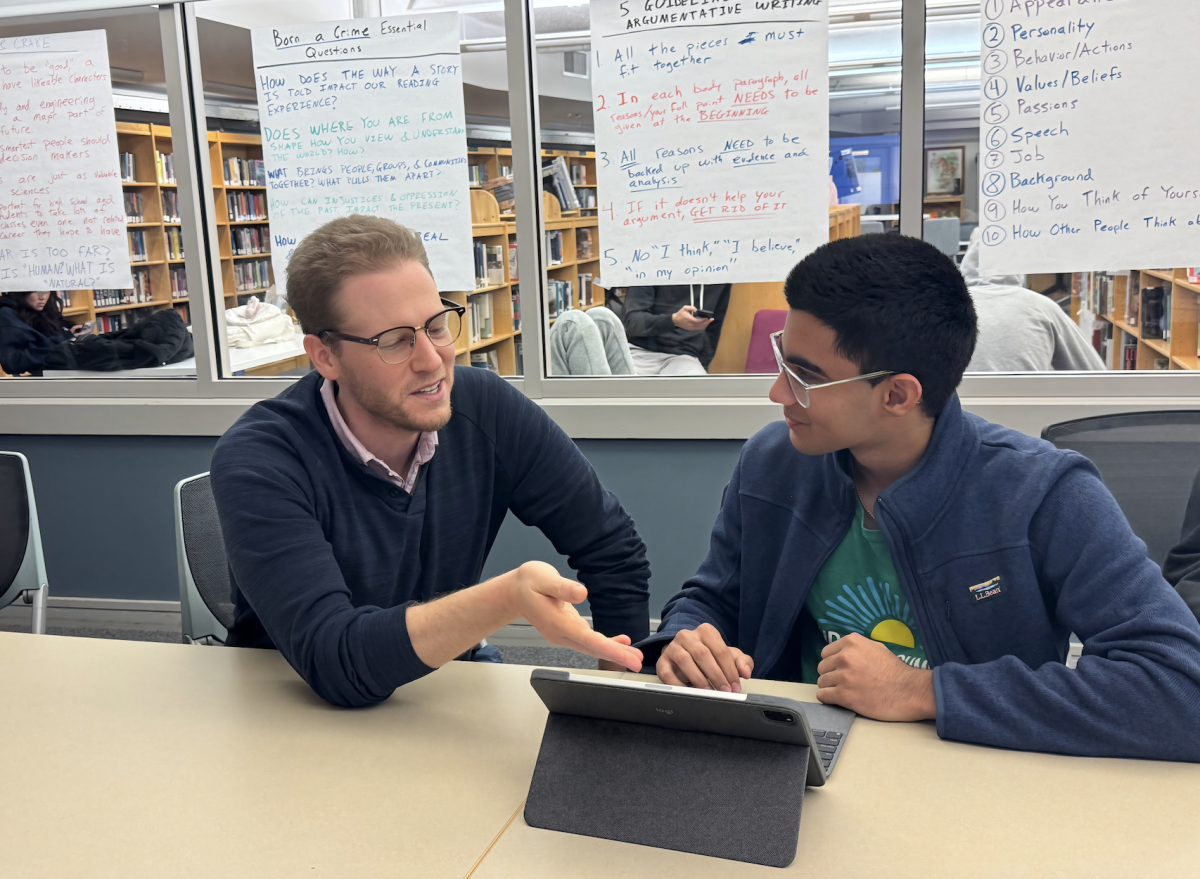 Photo illustration: Writing Center Director Bradley Starr models essay revision with Rohan Muni '28.