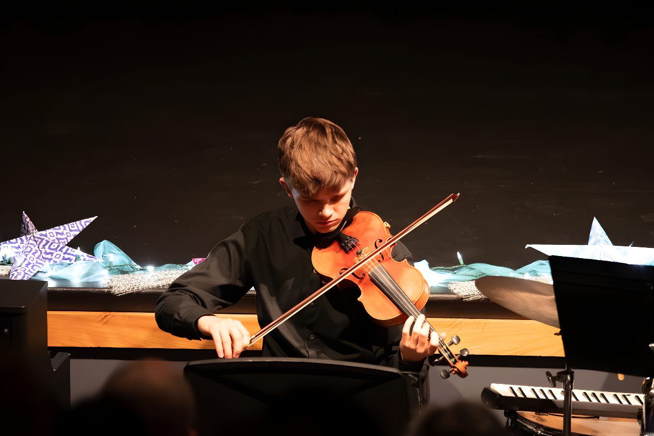 An hour of music community spirit filled the packed theater Thursday evening as students from across divisions showcased their talents at the annual Winter Concert.