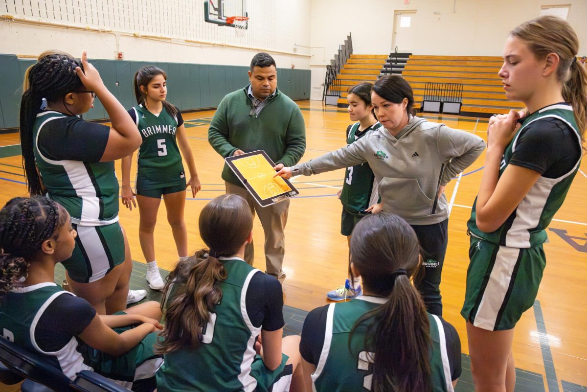 Coach Bonfiglio and Coach Erin Woodbury lead the huddle.